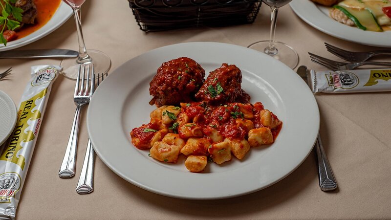 Gnocchi pasta entree with side of meatball