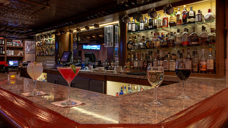 Multiple cocktails on bar top