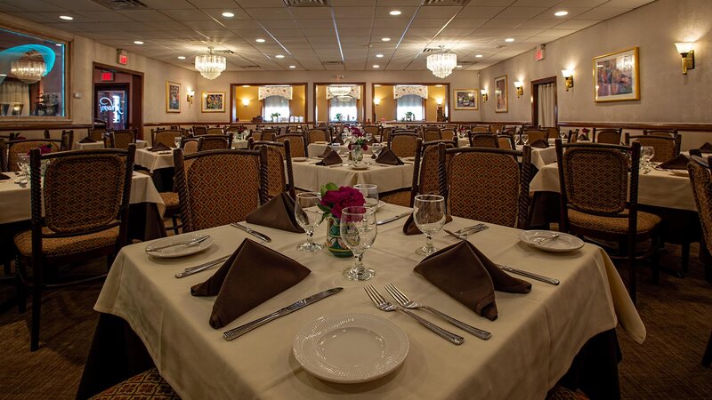 Dining room with focus on set table for four guests